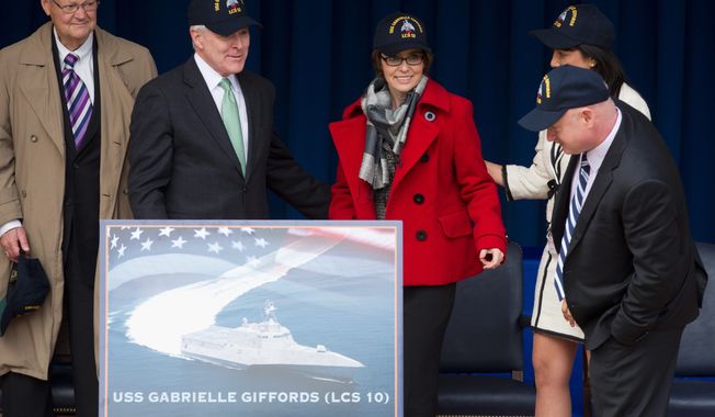 From left; Former Missouri Rep. Ike Skelton, Navy Secretary Ray Mabus, former Arizona Rep. Gabrielle Giffords, D-Ariz., her husband Mark Kelly, and Roxanna Green, obscured, the mother of the nine-year-old Christina-Taylor Green who was killed while attending the meeting of constituents when Giffords was shot, attend a ceremony at the Pentagon, Friday, Feb. 10, 2012, to unveil the USS Gabrielle Giffords. The Navy has named a ship for Gabrielle Giffords, the recently retired congresswoman from Arizona who is recovering from a gunshot wound to the head received in January 2011. (AP Photo Manuel Balce Ceneta)