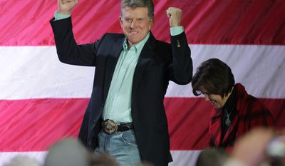 Idaho Gov. C.L. &quot;Butch&quot; Otter reacts to the crowd as he and his wife Lori, right, take the stage for a rally with Republican presidential candidate, former Massachusetts Gov. Mitt Romney, Friday, Feb. 3, 2012, in Elko, Nev. (AP Photo/Ted S. Warren)