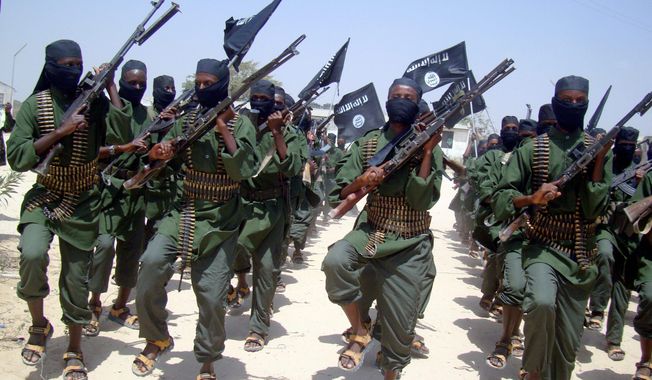 Al-Shabab fighters march with their weapons during military exercises on the outskirts of Mogadishu, Somalia, in February 2011. Over the past year, al-Shabab has lost much of the territory it held.  (Associated Press)