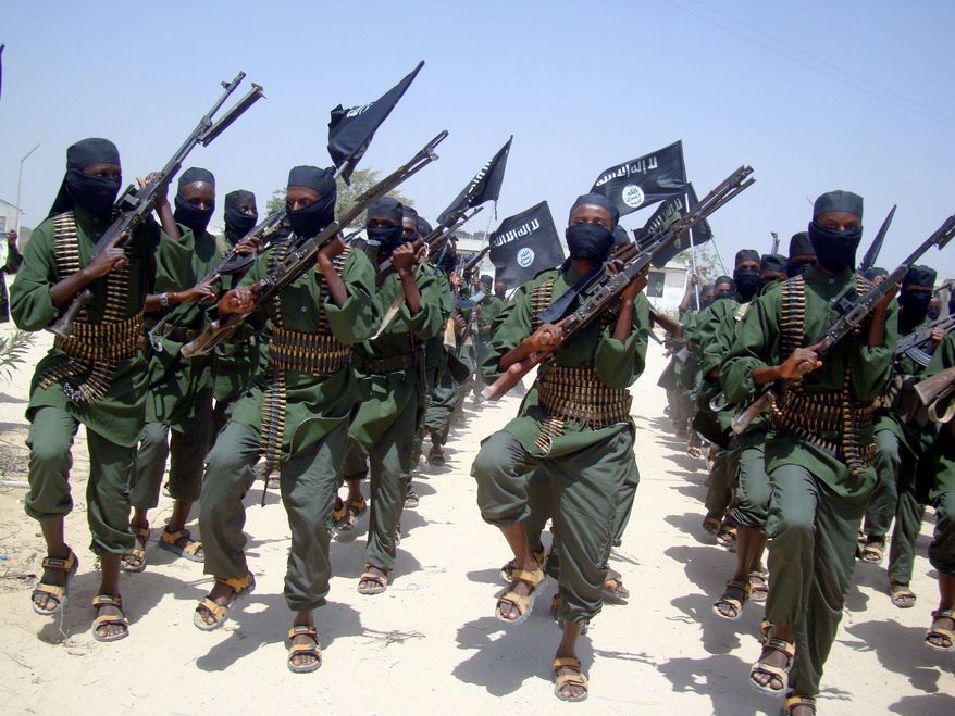 Al-Shabab fighters march with their weapons during military exercises on the outskirts of Mogadishu, Somalia, in February 2011. Over the past year, al-Shabab has lost much of the territory it held. (Associated Press)
