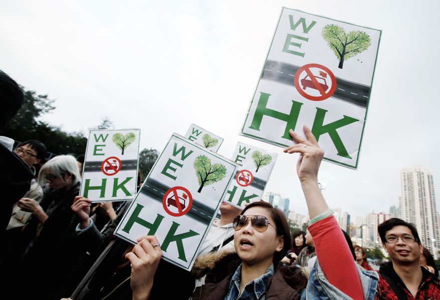 Protesters in Hong Kong stage a rally Sunday against what they consider the bad manners of Chinese mainlanders driving into Hong Kong. The visitors are frequently derided as “locusts” for their voracious buying of everything from luxury goods to baby formula. (Associated Press)