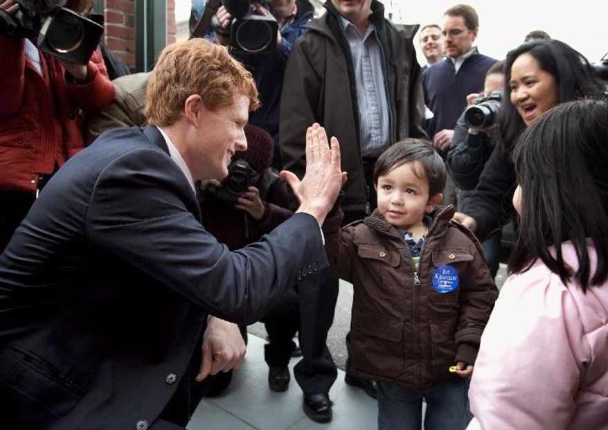 Joseph Kennedy III exchanges a greeting with 3-year-old Matthew Olsen, of Attleboro, Mass., during a campaign stop Thursday. Mr. Kennedy is running for the congressional seat held by retiring U.S. Rep. Barney Frank. (Associated Press)
