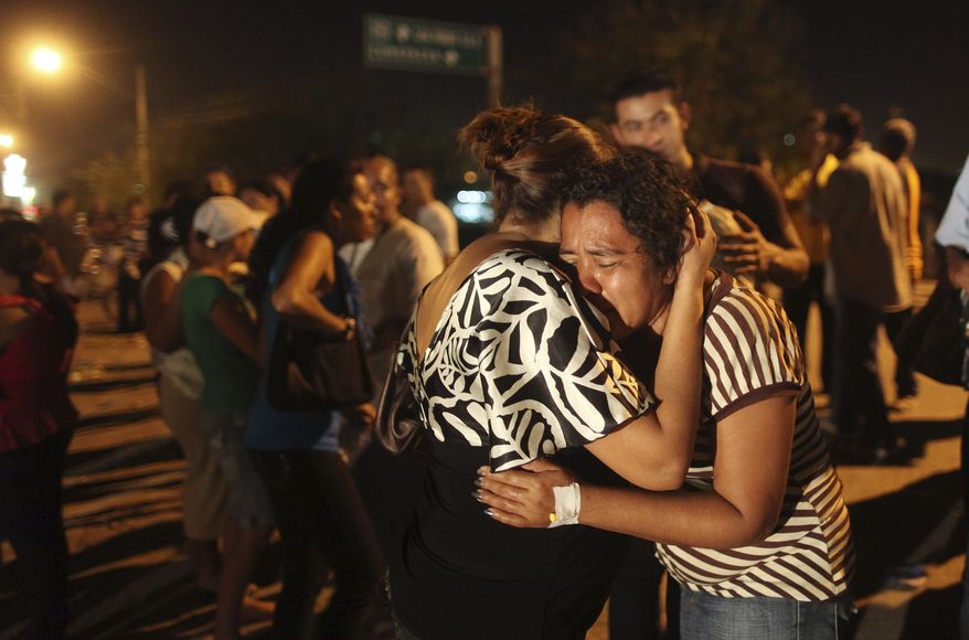 Blanca Flores, wife of dead inmate Oscar Soto, cries outside the prison in Comayagua, Honduras, on Wednesday Feb. 15, 2012. A fire started by an inmate late Tuesday tore through the prison, killing 358 inmates, said Supreme Court Justice Richard Ordonez, who is leading the investigation. (AP Photo/Esteban Felix)