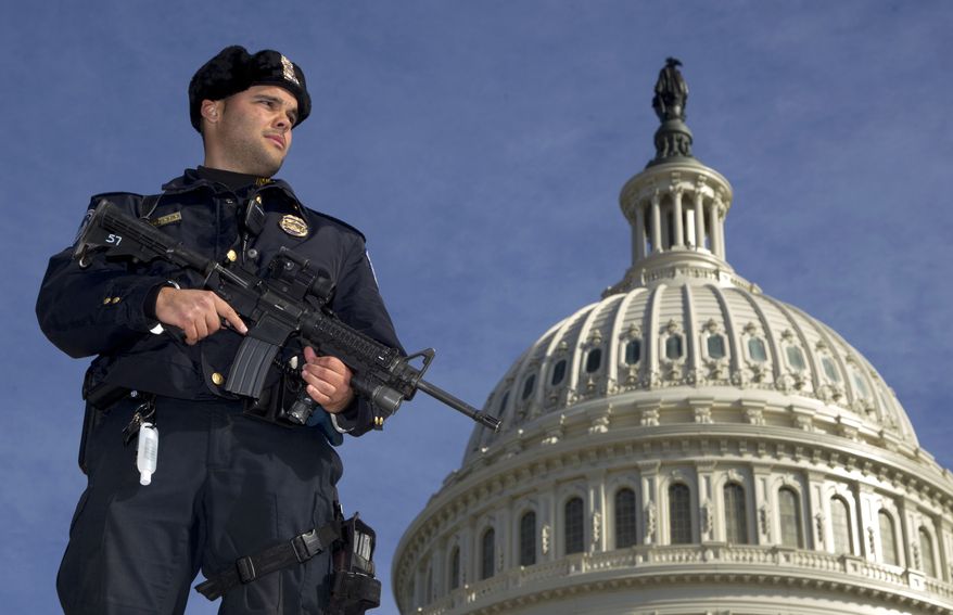 Capitol Police officer Angel Morales stands on guard Feb. 17, 2012, on the west side of the U.S. Capitol in Washington, after a 29-year-old Moroccan man was arrested in an FBI sting operation near the Capitol while planning to detonate what police say he thought were live explosives. (Associated Press)