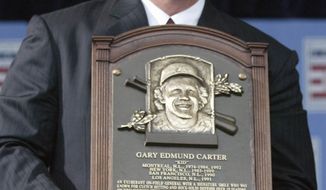FILE - In this July 27, 2003, file photo, National Baseball Hall of Fame Inductees Gary Carter holds his plaque during induction ceremonies in Cooperstown, N.Y. Baseball Hall of Fame president Jeff Idelson said Thursday, Feb. 16, 2012, that Hall of Fame catcher Gary Carter has died. He was 57.(AP Photo/John Dunn, File)
