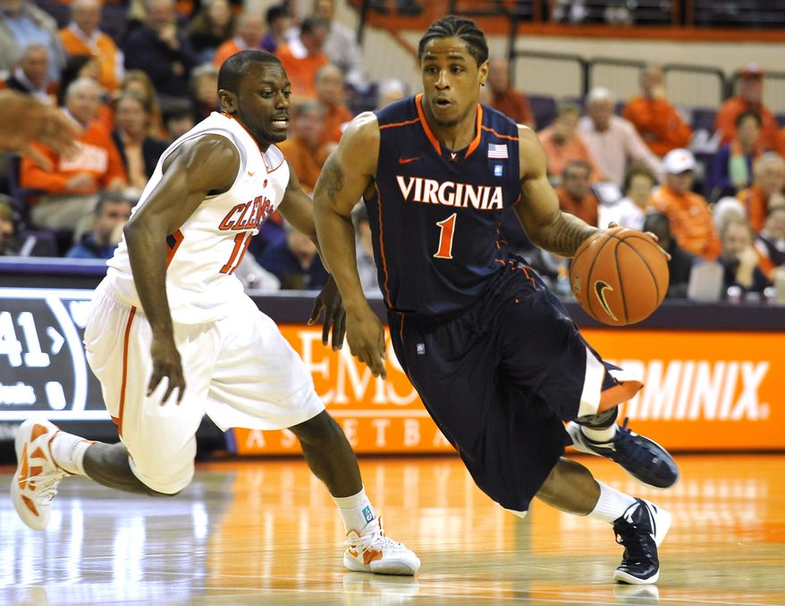 Virginia's Jontel Evans drives past Clemson's Andre Young during the first half Tuesday, Feb. 14, 2012, in Clemson, S.C. Clemson won 60-48. (AP Photo/Rainier Ehrhardt)