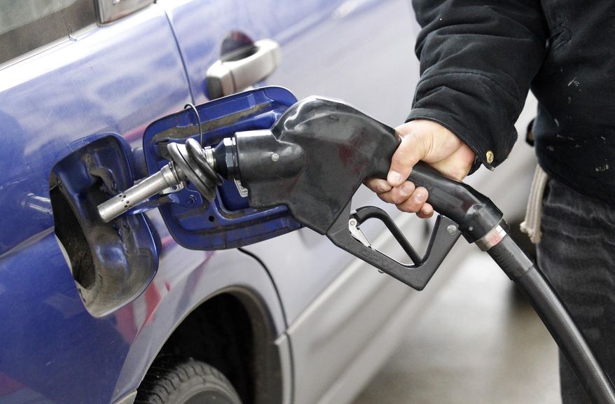 A service station attendant pumps gas in Portland, Ore., in February 2012. (AP Photo/Rick Bowmer)