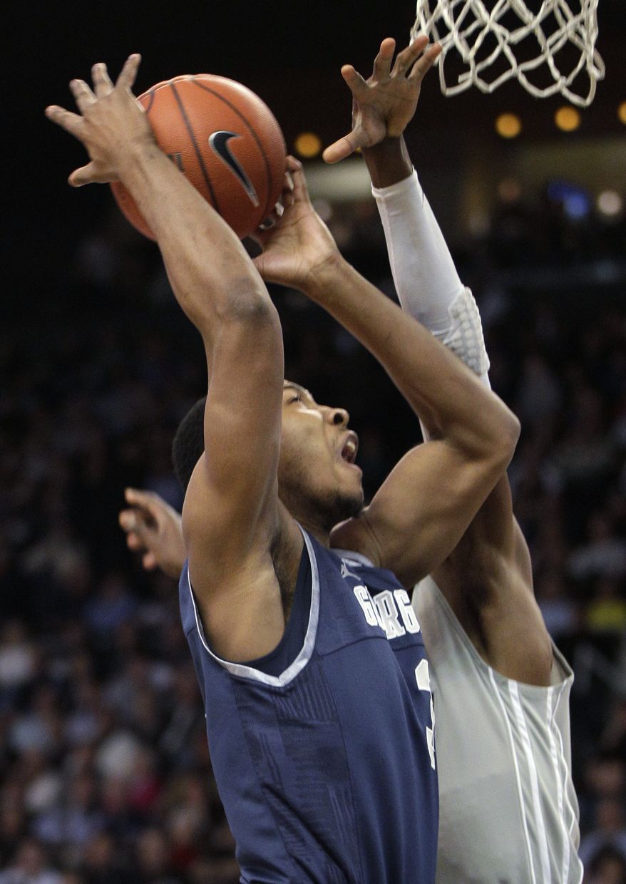 Georgetown forward Mikael Hopkins takes the ball to the basket against Providence forward Brice Kofane during the first half in Providence, R.I., Saturday, Feb. 18, 2012. (AP Photo/Stephan Savoia)