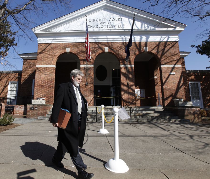 Commonwealth Attorney Warner Chapman leaves the Charlottesville Circuit courthouse after another delay in the trial of George Huguely V in Charlottesville, Va., Friday, Feb. 17, 2012. (AP Photo/Steve Helber)