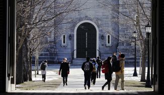 **FILE** People walk on the campus at Bowdoin College in Brunswick, Maine, on Feb. 13, 2012. (Associated Press)