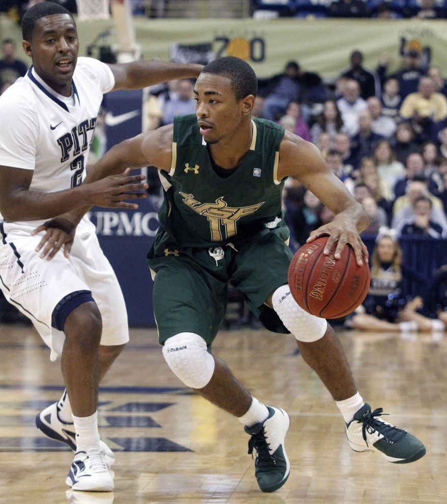 South Florida's Anthony Collins (11), drives past Pittsburgh's Isaiah Epps in the first half of an NCAA basketball game, Sunday, Feb. 19, 2012, in Pittsburgh. South Florida won 56-47. (AP Photo/Keith Srakocic)