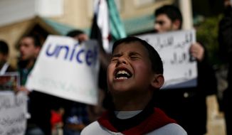A Syrian boy chants slogans Feb. 20, 2012, during a rally demanding UNICEF to protect Syrian children in front of the UNICEF Compound in Amman, Jordan. (Associated Press)