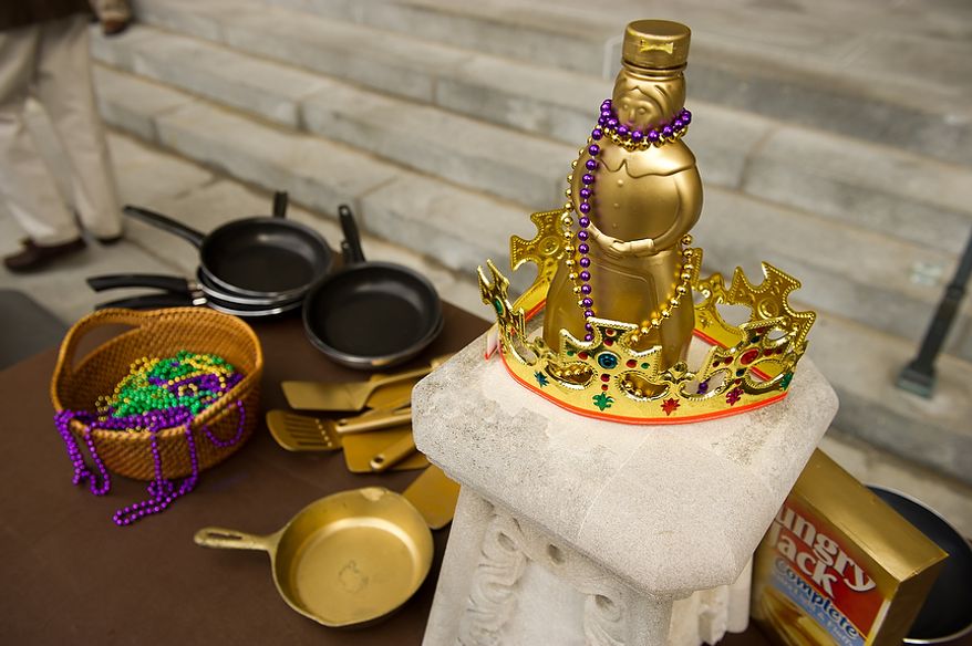 Golden skillets, a crown, a "Golden Mrs. Butterworth", and beads sit on an awards table before the start of the Washington National Cathedral Pancake Races held in front of the Cathedral on Shrove Tuesday, more commonly known as "Mardi Gras.", Washington, D.C., Tuesday, Feb. 21, 2012. This years annual Pancake Races are entitled the “Shake, Rattle & Race Edition,†in light of the earthquake damage the cathedral sustained earlier this year. (Andrew Harnik/The Washington Times)
