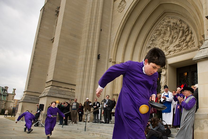 Left to right: Seventh grader Guyton Harvey and eighth grader Justin Frazier struggle to keep up as six grader Zachary Martin, right, wins the St. Albans School Boy Chorister race during the Washington National Cathedral Pancake Races held in front of the Cathedral on Shrove Tuesday, more commonly known as "Mardi Gras.", Washington, D.C., Tuesday, Feb. 21, 2012. This years annual Pancake Races are entitled the “Shake, Rattle & Race Edition,†in light of the earthquake damage the cathedral sustained earlier this year. (Andrew Harnik/The Washington Times)