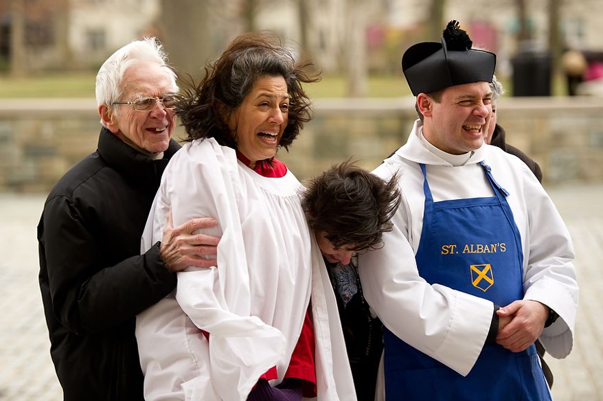 Left to right: Head Volunteer Coordinator for St. Alban's David Johnson, Director of Music of St. Alban's and last years pancake race champion Sonya Sutton, Parish Coordinator for St. Alban's Annemarie Stroud, and Assistant Rector for St. Alban's Parish Reverend Matthew Hanisian react to cold winds before the start of the Washington National Cathedral Pancake Races held in front of the Cathedral on Shrove Tuesday, more commonly known as "Mardi Gras.", Washington, D.C., Tuesday, Feb. 21, 2012. This years annual Pancake Races are entitled the “Shake, Rattle & Race Edition,†in light of the earthquake damage the cathedral sustained earlier this year. (Andrew Harnik/The Washington Times)