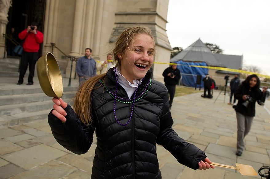 National Cathedral School student Annabel Ashcom Ricks, 13, gets a "golden skillet" for winning her race during the Washington National Cathedral Pancake Races held in front of the Cathedral on Shrove Tuesday, more commonly known as "Mardi Gras.", Washington, D.C., Tuesday, Feb. 21, 2012. This years annual Pancake Races are entitled the “Shake, Rattle & Race Edition,†in light of the earthquake damage the cathedral sustained earlier this year. (Andrew Harnik/The Washington Times)