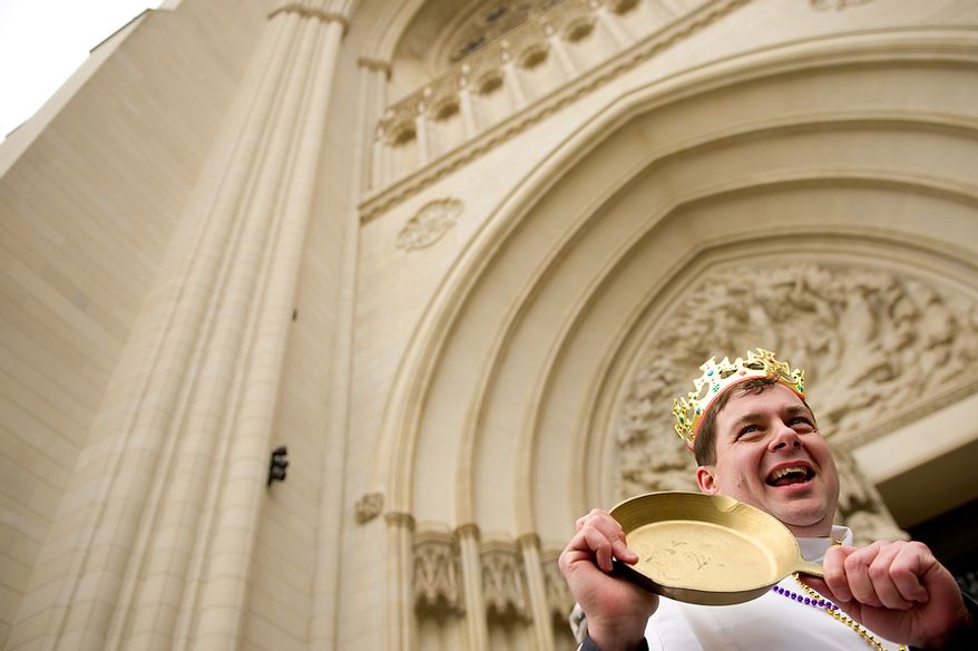 Assistant Rector for St. Alban's Parish Reverend Matthew Hanisian proudly shows off his "golden skillet" after winning the final champion's race at the Washington National Cathedral Pancake Races held in front of the Cathedral on Shrove Tuesday, more commonly known as "Mardi Gras.", Washington, D.C., Tuesday, Feb. 21, 2012. This years annual Pancake Races are entitled the “Shake, Rattle & Race Edition,†in light of the earthquake damage the cathedral sustained earlier this year. (Andrew Harnik/The Washington Times)