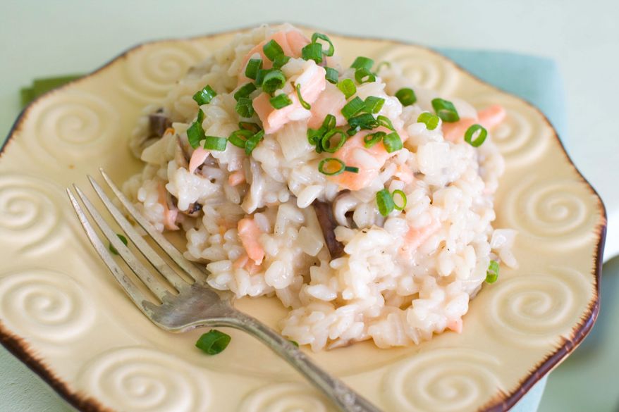 Cooking with champagne gives this risotto with sliced shiitake mushrooms and salmon a celebratory attitude. (Associated Press)