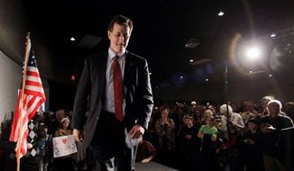 Former Sen. Rick Santorum of Pennsylvania, a GOP presidential hopeful, walks off stage after speaking at a rally in Traverse City, Mich., on Sunday. (Associated Press)