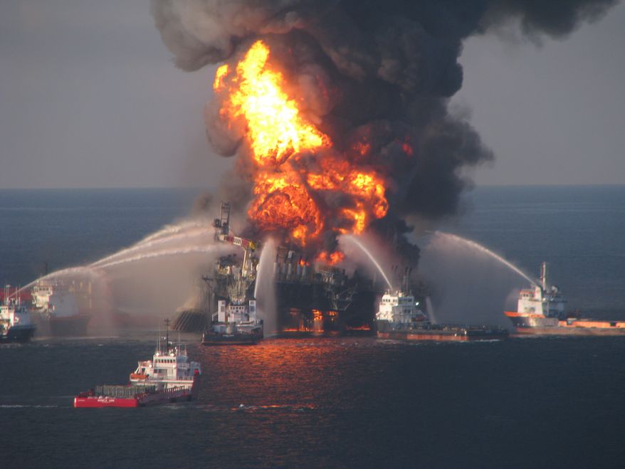 ** FILE ** Fire-boat response crews spray water on the burning remnants of BP's Deepwater Horizon offshore oil rig on April 21, 2010. (AP Photo/U.S. Coast Guard)