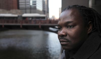Nigerian-born Charles Wiwa, 44, shown in Chicago on Thursday, Feb. 16, 2012, fled Nigeria in 1996 following a crackdown on protests against Shell’s oil operations in the Niger Delta.  (AP Photo/Charles Rex Arbogast)