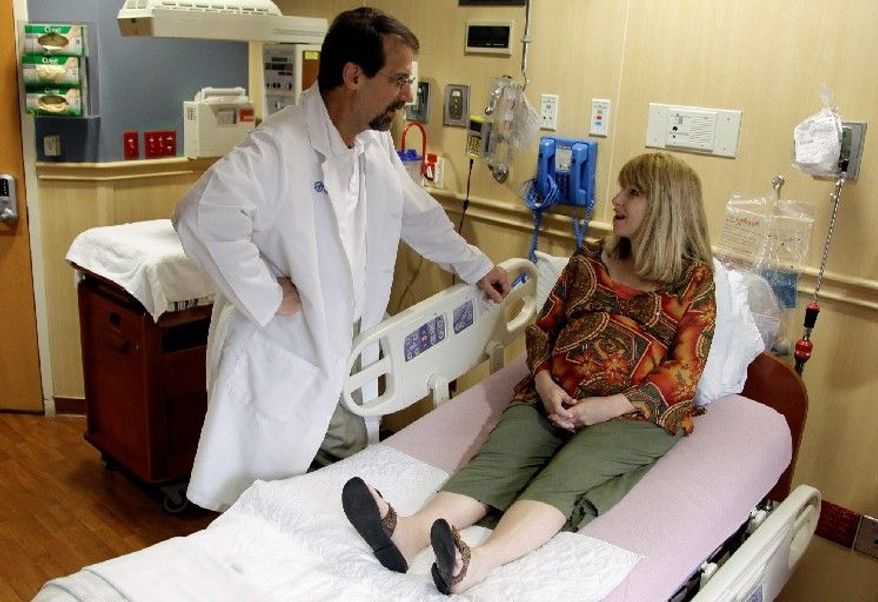 **FILE** Mother-to-be Tammy Gerencser speaks with Dr. Michael L. Cacciatore at Florida Hospital in Orlando. (Associated Press)