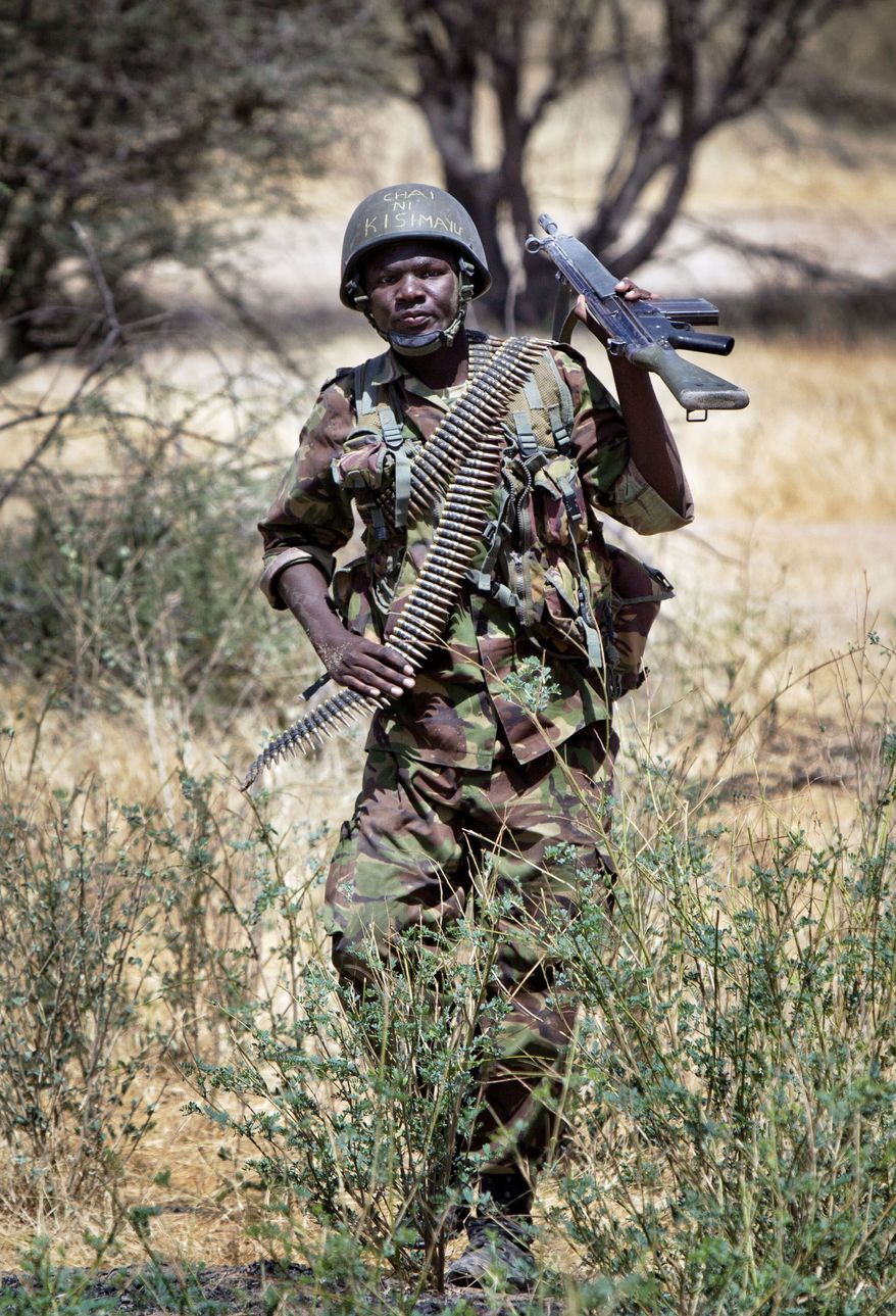 Kenyan soldier Nicholas Munyanya wears a helmet with the words written in Kiswahili "Tea in Kismayo," a reference to a strategic Somali town. (Associated Press)