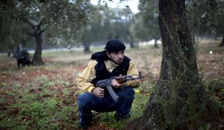 A Free Syrian Army fighter takes a position Feb. 27, 2012, as the Syrian Army advances towards the town of Sarmin, Syria. (Associated Press)