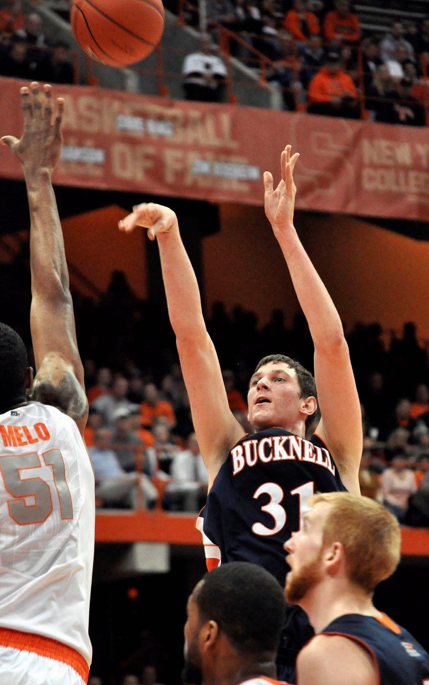 Bucknell's Mike Muscala shoots over Syracuse's Fab Melo, left, during the first half of an NCAA college basketball game in Syracuse, N.Y., Tuesday, Dec. 20, 2011. Syracuse won 80-61. (AP Photo/Kevin Rivoli)