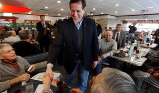Republican presidential candidate Rick Santorum greets diners Tuesday at New Beginnings Restaurant in Kentwood, Mich. In an attempt to defeat Mitt Romney in the state, Mr. Santorum&#39;s campaign actively solicited votes from an unlikely source: registered Democrats in Michigan. The AFSCME union is helping him with ad buys in Ohio. (Associated Press)