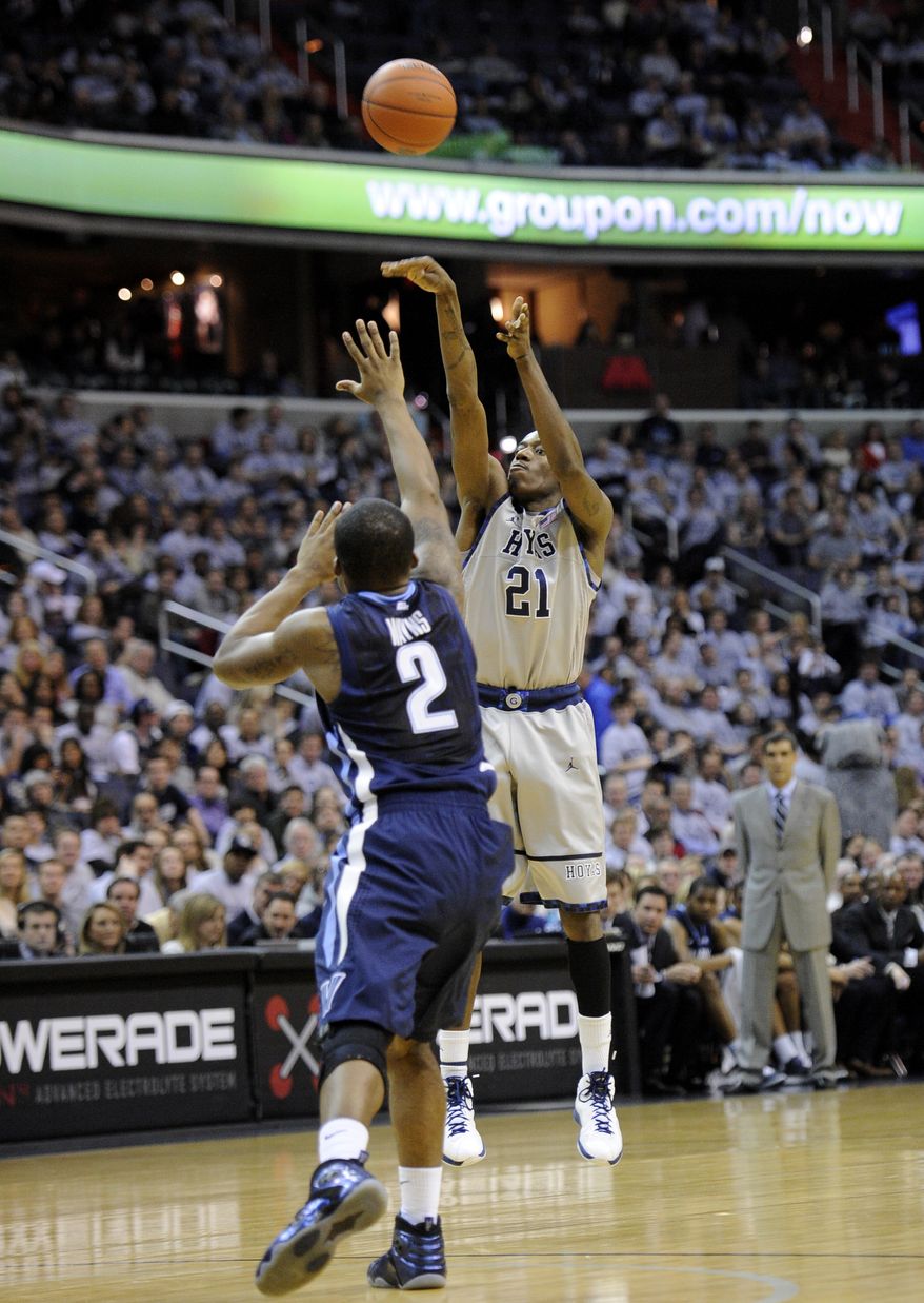 Georgetown guard Jason Clark takes a shot against Villanova guard Maalik Wayns during the second half Saturday, Feb. 25, 2012, in Washington. Georgetown won 67-46. (AP Photo/Nick Wass)