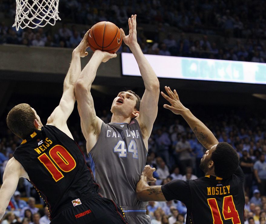 North Carolina's Tyler Zeller shoots while Maryland's Berend Weijs and Sean Mosley defend during the second half in Chapel Hill, N.C., Wednesday, Feb. 29, 2012. North Carolina won 88-64. (AP Photo/Gerry Broome)