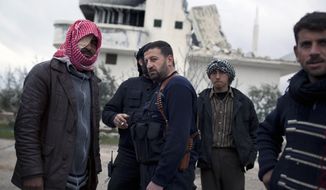 Free Syrian Army soldiers gather Feb. 28, 2012, outside a house destroyed in fighting against President Assad&#39;s forces in Sarmin, north Syria. (Associated Press)