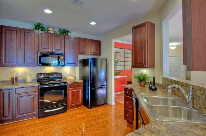 The kitchens at the Hampton Court condominiums at Legacy at Cherry Tree have 42-inch cabinets, a pantry and a breakfast bar.