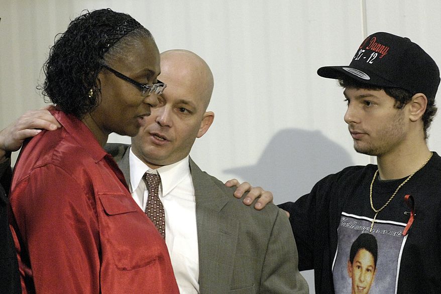 Ron Parmertor, uncle of Daniel Parmertor, center, and Daniel's brother Dominic, right, pause to comfort Phyllis Ferguson, mother of Demetrius Hewlin, Thursday, March 1, 2012, during a news conference in Eastlake, Ohio. Daniel Parmertor, Demetrius Hewlin and Russell King Jr. were killed by a gunman at Chardon High School Monday. (AP Photo/News-Herald, Maribeth Joeright)