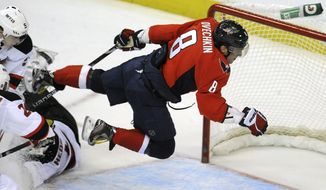 Washington Capitals&#39; Alex Ovechkin (8) leaps through the air after a shot on goal stopped by New Jersey Devils&#39; goalie Johan Hedberg (1) during the second period of an NHL game, Friday, March 2, 2012, in Washington. New Jersey defeated Washington 5-0. (AP Photo/Richard Lipski)