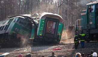 Rescuers work on Sunday, March 4, 2012, at the site where two trains collided head-on near Szczekociny, Poland, late on Saturday. (AP Photo/Wojtek Barczynski)