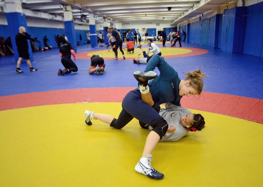 Helen Maroulis, a wrestler from Rockville, Md, may be the best U.S. wrestler in her weight class. She is currently training at the U.S. Olympic Training Center in Colorado Springs, Colo. She and other members of the U.S. team, as well as wrestlers from other countries, spent time training together, Thursday,Mar. 1, 2012. Maroulis and Venezuelan wrestler Marcia Andrades practice a two-arms one leg professional wrestling move. (Bryan Oller/Special to the Washington Times)