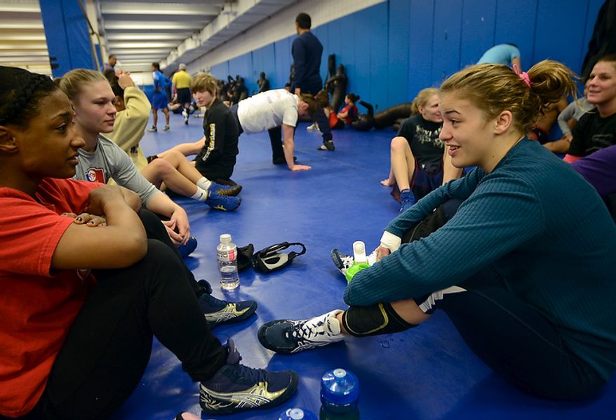 Helen Maroulis, a wrestler from Rockville, Md, may be the best U.S. wrestler in her weight class. She is currently training at the U.S. Olympic Training Center in Colorado Springs, Colo. She and other members of the U.S. team, as well as wrestlers from other countries, spent time training together, Thursday,Mar. 1, 2012. Maroulis, right, briefly chats with teammates before the start of morning workout. (BryanOller/Special to the Washington Times)