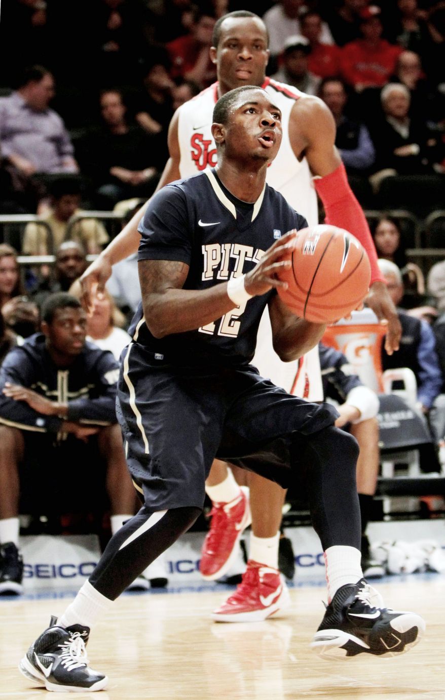 ASSOCIATED PRESS
Pittsburgh's Ashton Gibbs looks to shoot while St. John's God'sgift Achiuwa watches. Gibbs scored 20 points in the Panthers' 73-59 Big East tournament victory.