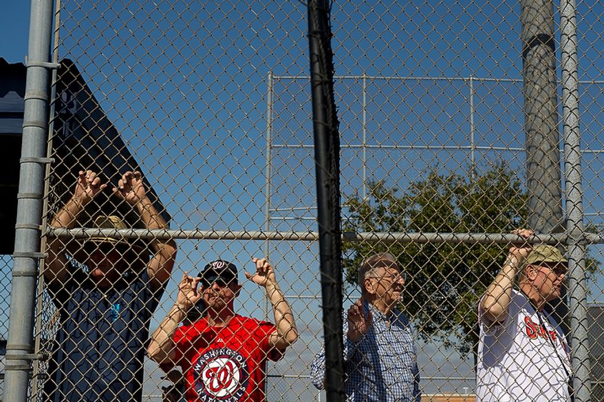 Left to Right: Lenny Strelitz, a player's agent, and fans Steve Heller of Fairfax, Va., Mike DiFrancesco of Viera, Fla., and Dwight Hurst of Harrisburg, Fla., watch the Washington Nationals work out during spring training, Viera, Fla., Tuesday, February 28, 2012. (Andrew Harnik/The Washington Times)