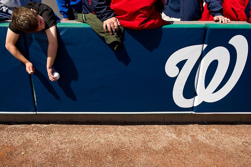 9 year old Jimmy McCrae of Palm Bay, Fla., waits for players to arrive to sign his baseball before the Washington Nationals play the Houston Astros during a spring training game at Space Coast Stadium, Viera, Fla., Sunday, March 4, 2012. The Nationals lost to the Asros 10-2. (Andrew Harnik/The Washington Times)