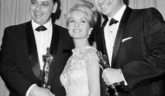 **FILE** Actress Debbie Reynolds poses April 5,1965, in Santa Monica Calif., with Academy Award winners for best music Richard M. Sherman (right) and Robert Sherman, who received the award for &quot;Mary Poppins.&quot; Songwriter Sherman, who wrote the tongue-twisting &quot;Supercalifragilisticexpialidocious&quot; and other enduring songs for Disney classics, died March 5, 2012. He was 86. (Associated Press)