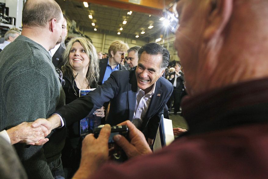 Mitt Romney greets supporters at Taylor-Winfield Technologies in Youngstown, Ohio. The GOP presidential candidate pushed his theme of more jobs and smaller government. (Associated Press)