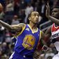 Golden State Warriors guard Monta Ellis (8) puts up a shot as he is guarded by Washington Wizards forward Chris Singleton during the first quarter of an NBA game at Verizon Center in Washington, on Monday, March 5, 2012. The Warriors won 120-100. (AP Photo/Jacquelyn Martin)