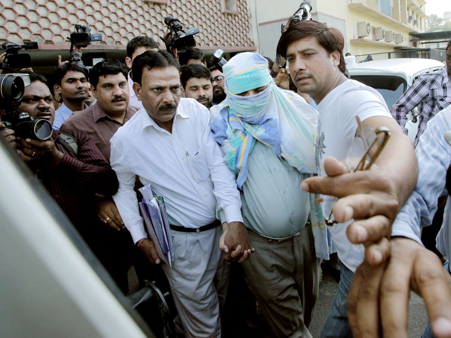 Policemen escort Syed Mohammed Kazmi, linked to last month's bombing of an Israeli diplomat's vehicle, from a local court in New Delhi on Wednesday. The arrest of the Indian journalist is the first apparent breakthrough in an attack that Israel accused Iran of orchestrating. (Associated Press)