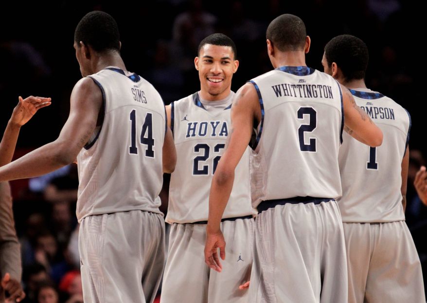 Georgetown's Otto Porter (facing camera) is congratulated by (from left) Henry Sims, Greg Whittington and Hollis Thompson during his 20-point, six-rebound performance. (Associated Press)