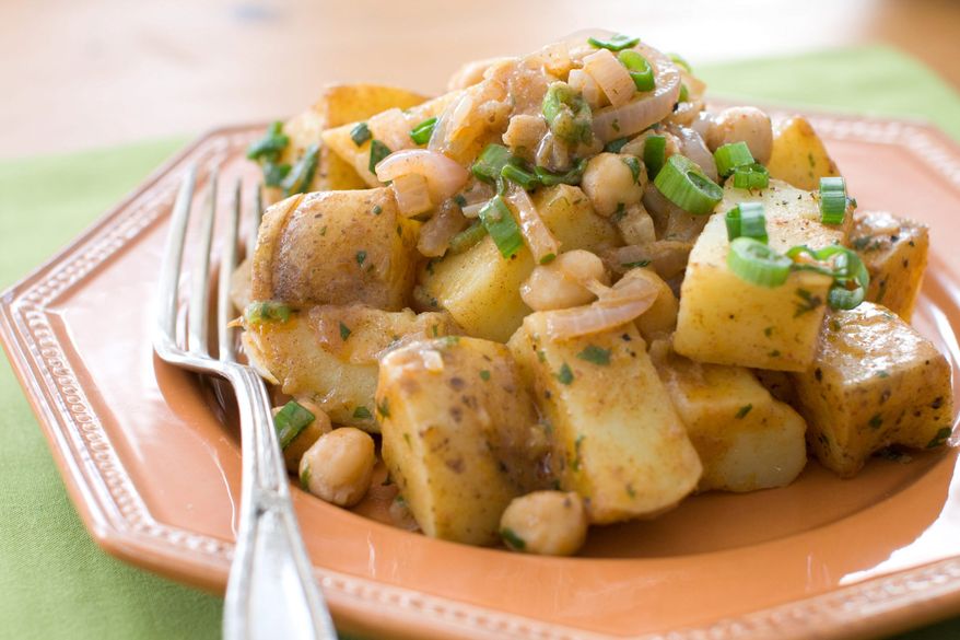 A dish of red curry potatoes and chickpeas, a great from-scratch recipe you can have on the table in under 30 minutes. (AP Photo/Matthew Mead)