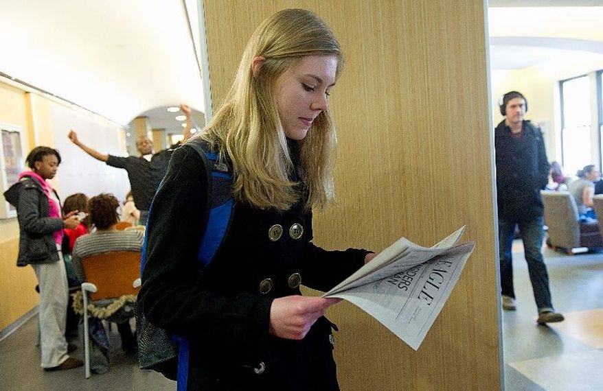 The print version of American University's newspaper the Eagle remains popular on campus. Freshman Lizzy Menstell, checking out the Tuesday issue, says she enjoys reading the Eagle grams - funny anecdotes in the print edition. (Barabara L. Salisbury/The Washington Times)