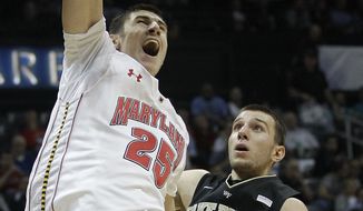Maryland center Alex Len dunks the ball against Wake Forest center Carson Desrosiers in the second half of of the first-round Atlantic Coast Conference tournament game, Thursday, March 8, 2012, in Atlanta. (AP Photo/Chuck Burton)